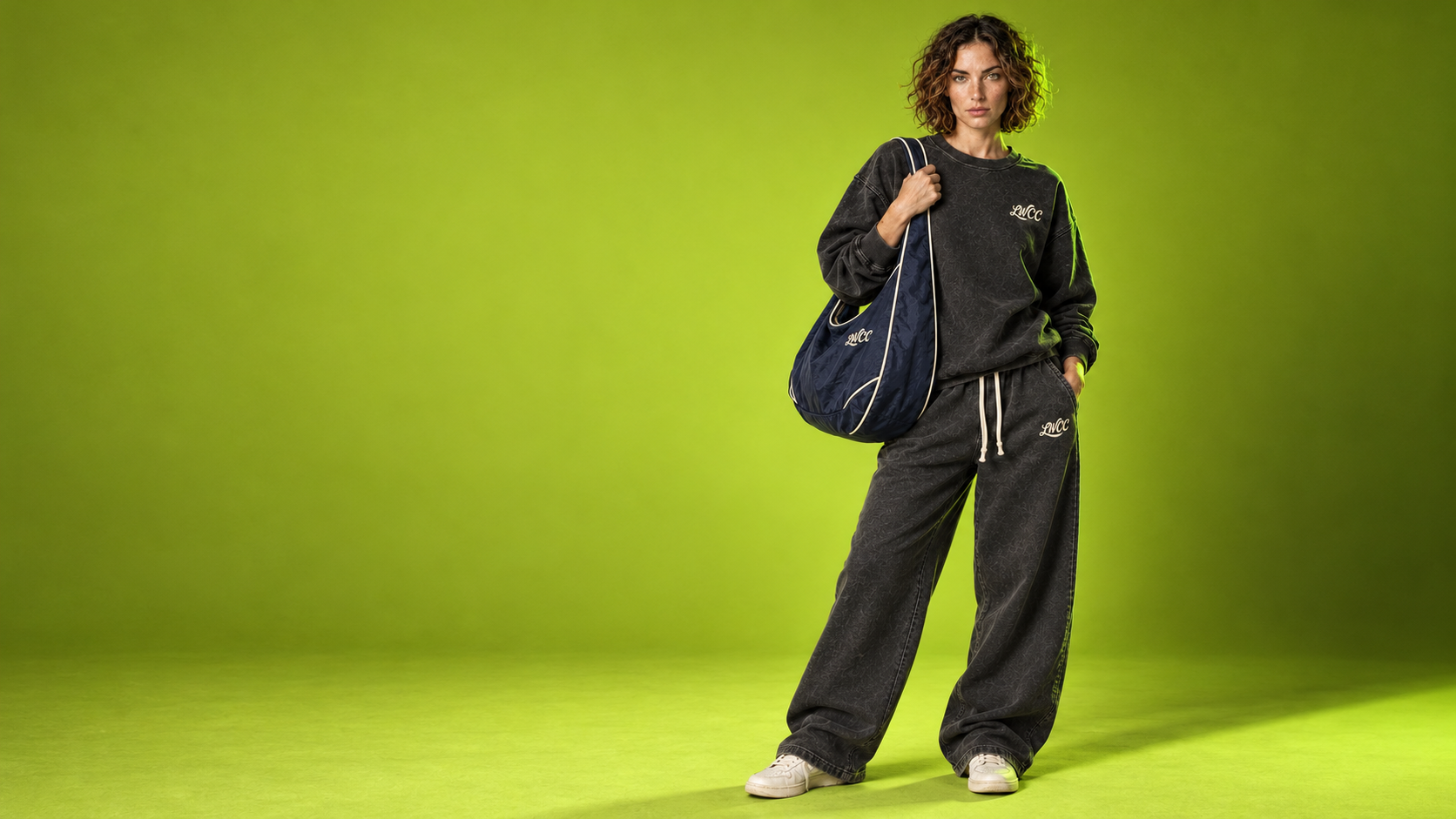 Lost Wight fashion campaign, with a model wearing charcoal sweats against vivid green
